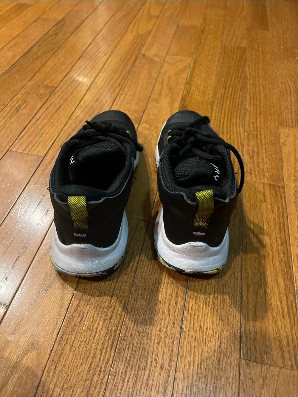 Under Armour Kids Black and White Sneakers with Yellow Accents